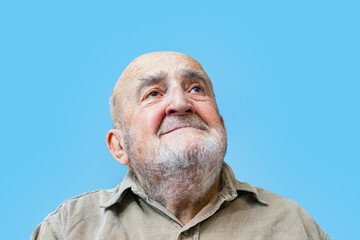 happy old man looking above isolated on blue