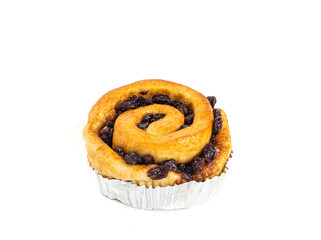 Roll with raisins in foil on white background. One bun or cinnamon isolated picture. Homemade bakery concept.