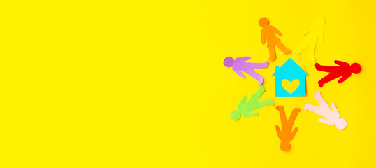 Diversity, inclusion, adoption concept. Colorful paper cut figure on yellow background. Banner
