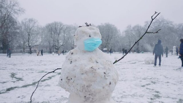 Mid shot of a snowman during the corona pandemic in London.