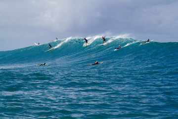 A group of Surfers riding a Wave in Hawaii - 408181419