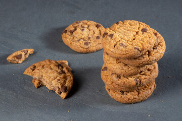 freshly baked Chocolate chip cookies on a dark stone with place for text. Copy space.