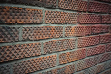 Old brick wall close up. Rhombus patterned brick.
