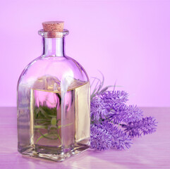 Obraz na płótnie Canvas Herbal oil and lavender flowers on wooden table.