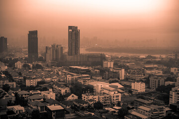 The high angle background of the city view with the secret light of the evening, blurring of night lights, showing the distribution of condominiums, dense homes in the capital community