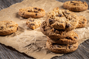 freshly baked Chocolate chip cookies on a wooden table with place for text. Copy space.