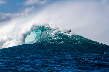 A Surfer riding over a wave in Hawaii - 408182863