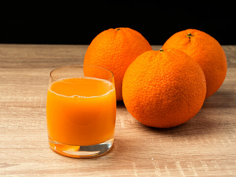 Glass Glass With Orange Juice And Orange Stand On A Wooden Gray Table