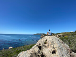 Obraz premium person on a rock ocean view California 