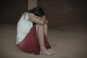 Human trafficking concept.Sad Young girl sit alone feeling bad in old room.women victims of...