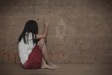 Human trafficking concept.Sad Young girl sit alone feeling bad in old room.women victims of trafficking.