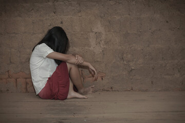Human trafficking concept.Sad Young girl sit alone feeling bad in old room.women victims of trafficking.