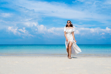 cheerful woman walking on sea beach at Koh MunNork Island, Rayong, Thailand
