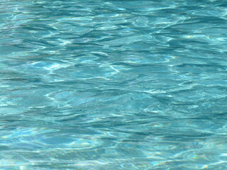 Blue water background texture with light reflexions