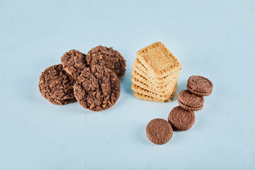Chocolate and oatmeal cookies on blue background