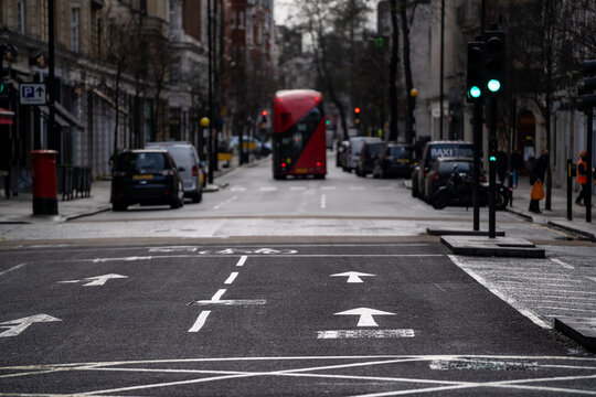 London, UK - January 13 2021 - A street in London with a red bus during coronavirus lockdown