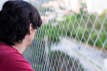 Man on balcony with safety net for pets