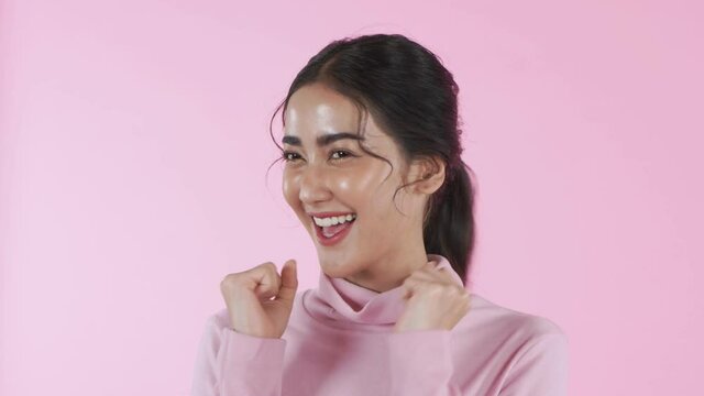 Beauty concept of 4k Resolution. Young Asian women are surprised and excited on a pink background.
