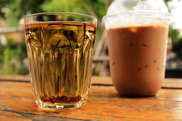 Traditional Thai hot tea. Glass of hot Thai tea on the wood table.