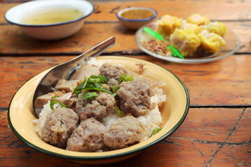 Dried Rice with pork and steamed pork sausage in yellow zinc bowl. Asian breakfast style.
