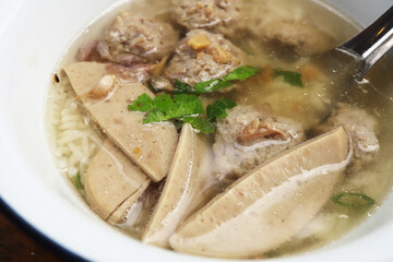 Boiled rice with pork and steamed pork sausage in White zinc bowl. Asian breakfast style.
