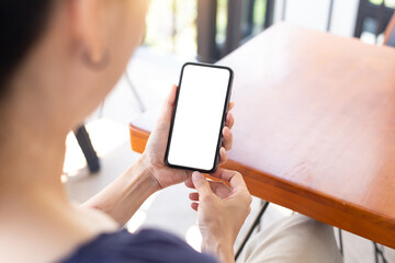 cell phone blank white screen mockup.woman hand holding texting using mobile on desk at office.background empty space for advertise.work people contact marketing business,technology