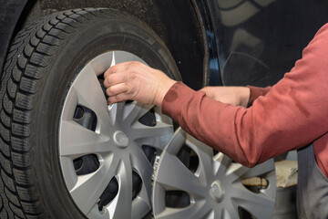 Handyman In Tire Changing In A Power Station With A Impact Driver