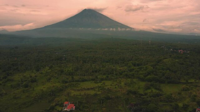 aerial view amed bali indonesia little fisherman village on the ocean with active mount volcano during colorful sunset