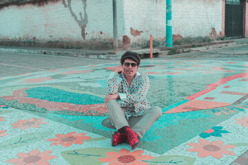 model sitting on colorful street, 70s style dress. colonial town. mosaic