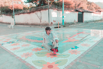 model sitting on colorful street, 70s style dress. colonial town. mosaic
