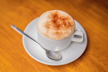 Top view a cup of Giang egg coffee on wood background. Vietnamese coffee in Ha Noi, Vietnam. Eggs are beaten with coffee, hot drink or with ice