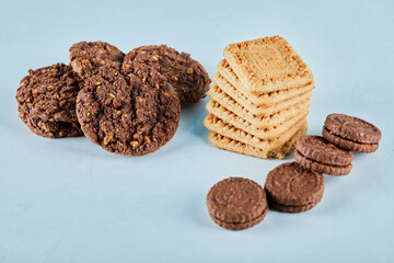 Chocolate and oatmeal cookies on blue background