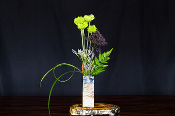 Ikebana , Japanese flower arrangement, simply putting flowers in a container. 