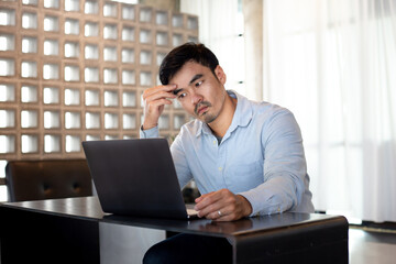 sad depression serious people from work,study stress concept.asian man feeling tired suffering using computer working work place.concept global economic,health problems