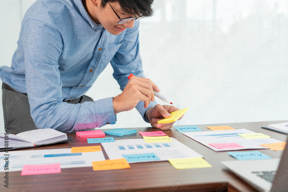 Poster businessman stick colorful notes to brainstorming on the table working on new project to share idea 
