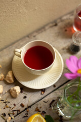 Cup of red tea on table
