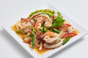Spicy seafood salad with steamed shrimp and squid. Popular Thai dishes
