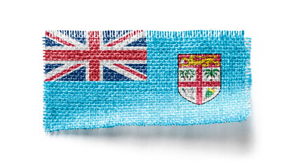 Fiji flag on a piece of cloth on a white background