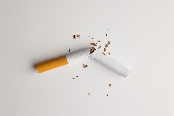 A broken cigarette on a white table Visual content about quitting smoking. world tobacco day.
