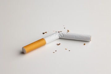 A broken cigarette on a white table Visual content about quitting smoking. world tobacco day.