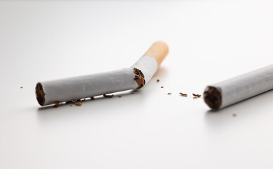 A broken cigarette on a white table Visual content about quitting smoking. world tobacco day.