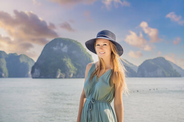 Attractive woman in a dress is traveling in Halong Bay. Vietnam. Travel to Asia, happiness emotion, summer holiday concept. Picturesque sea landscape. Ha Long Bay, Vietnam