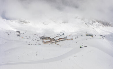 Fototapeta na wymiar Aerial droe shot of Sonnalpin station restaurant in heavy snow below Zugspitze Top of Germany