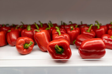 Red pepper (chili) on the white shelf in the supermarket