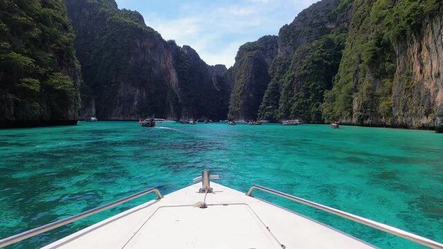 Selective focus of beautiful deck of yacht sailing in the ocean waters surrounded with greenery and mountains of Phi Phi Island, Phuket, Thailand