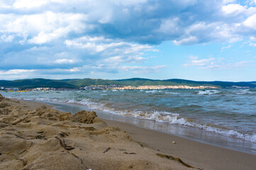 Sea surf, waves rolls on a sandy beach