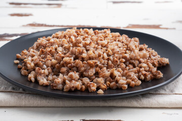 Boiled buckwheat on a plate. Healthy porridge enriched with vitamins. copy space,