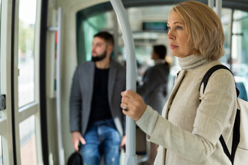Fototapeta na wymiar Adult female passenger traveling in tram. High quality photo