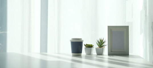 Mockup workspace desk and copy space book,plant and coffee on wood desk.
