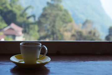 Cup of coffee at hillside with beautiful view of mountain. Phahee Mountain View Chiangrai, Thailand.